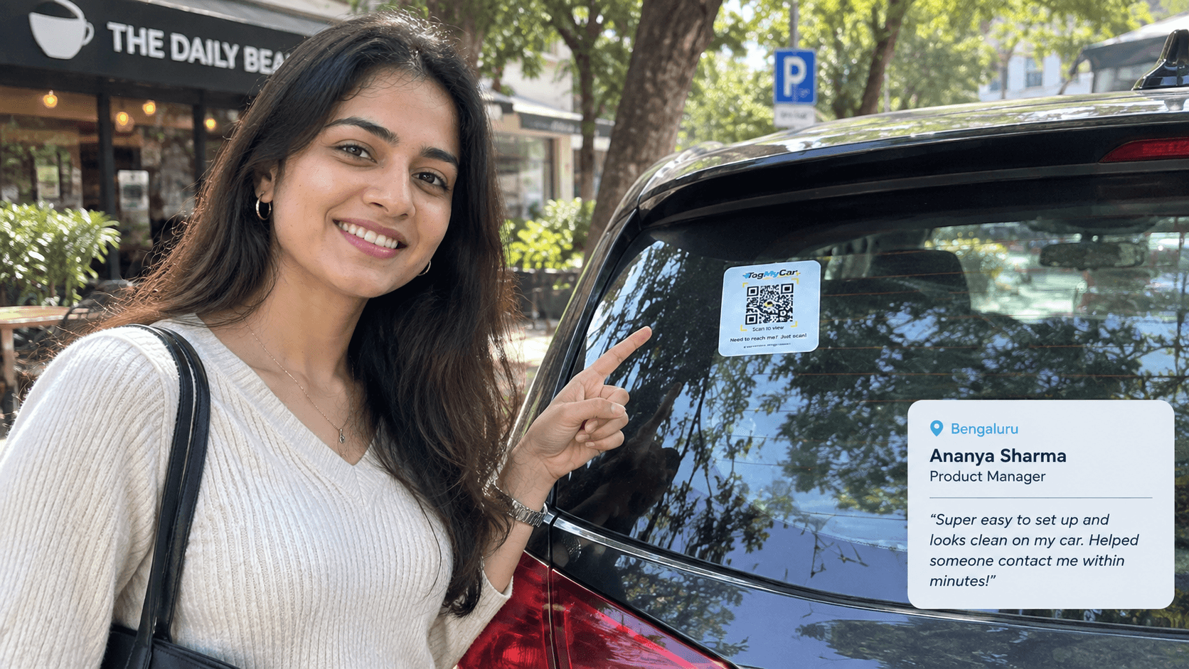Ananya, a TagMyCar customer, pointing at the TagMyCar QR tag on her car's rear windshield outside a cafe in Bengaluru